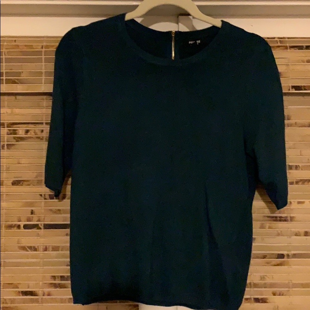 Dark green sweater with zipper detailing on back.